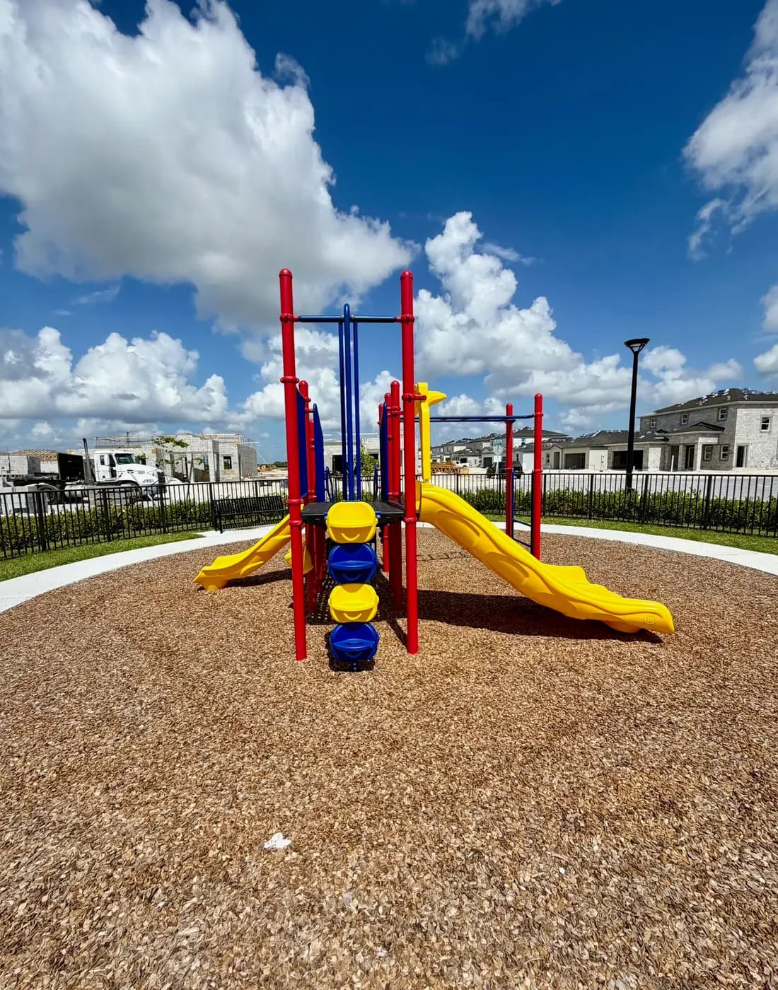 Acacia Groves play system with the new community homes behind it