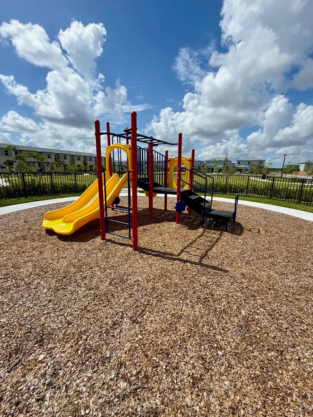 Smaller play structure for younger kids on engineered wood fiber at Acacia Groves