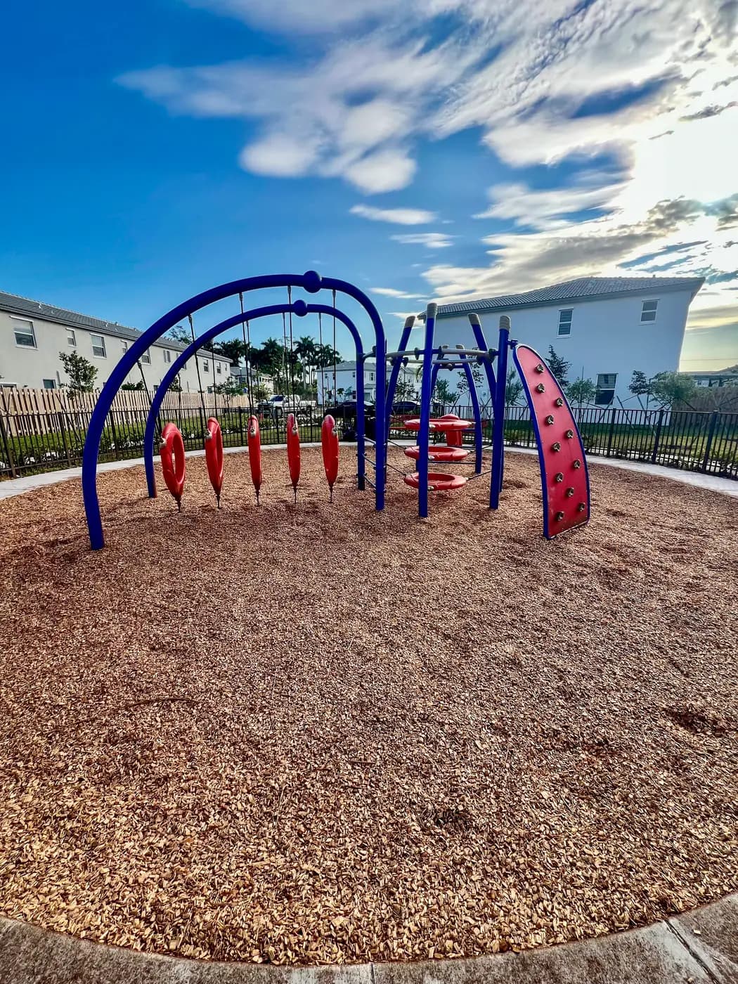 Climbing arches with hanging pods and a red climbing wall