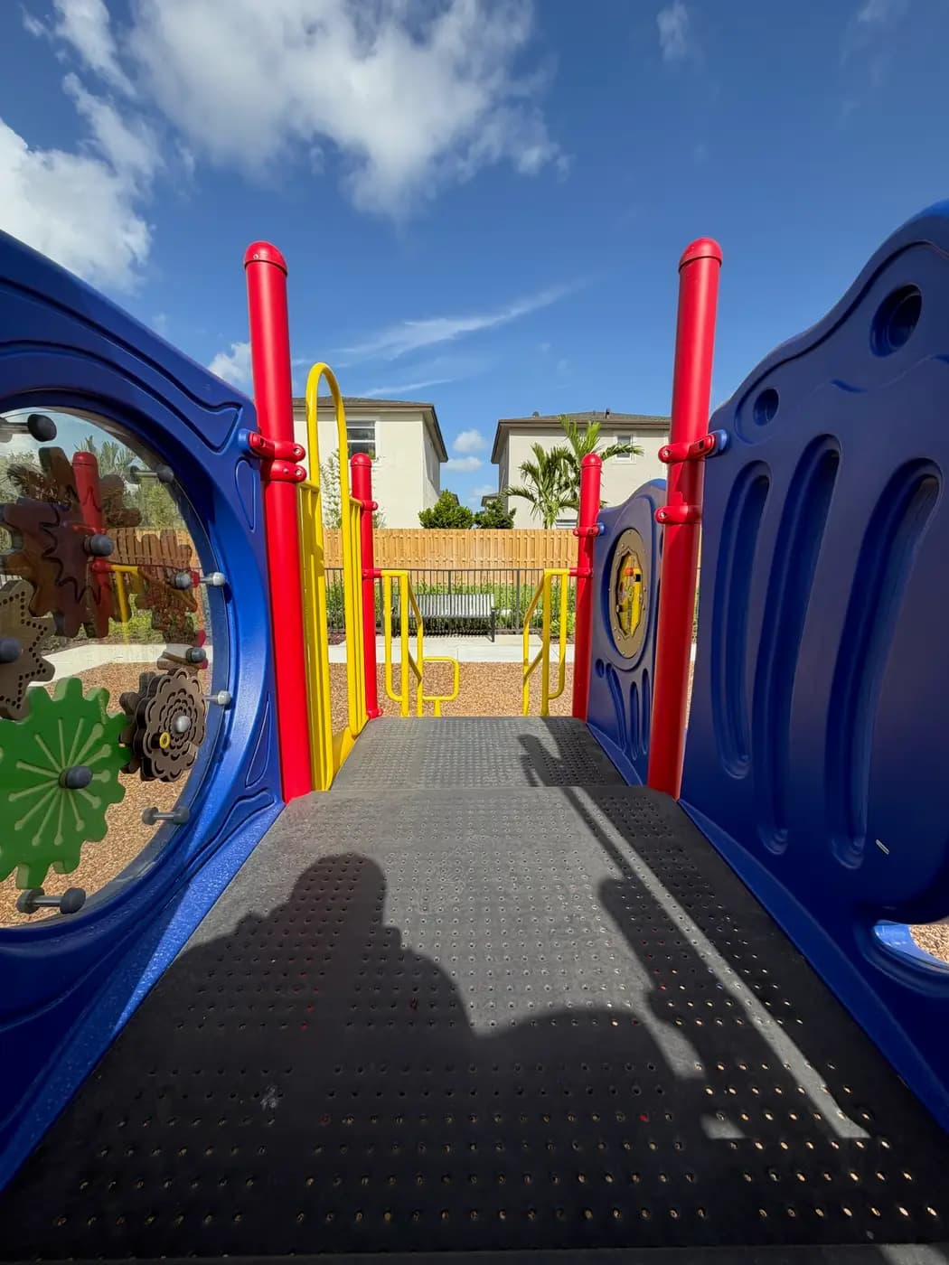 Blue play panel and red posts on the Coral Landings playground