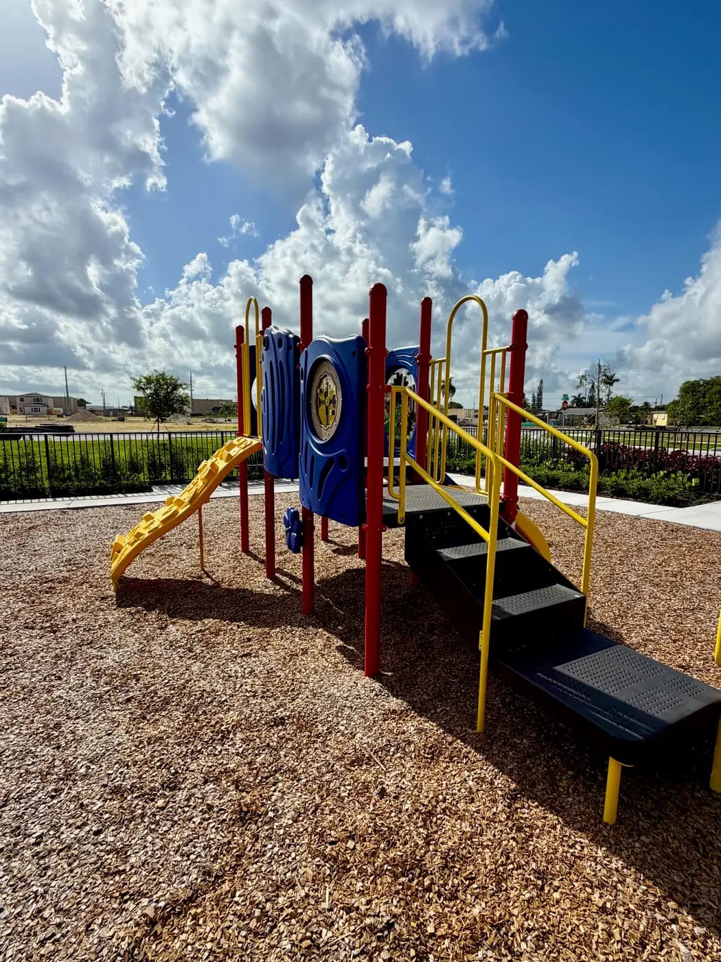 Play towers with blue activity panels and a yellow climbing ramp