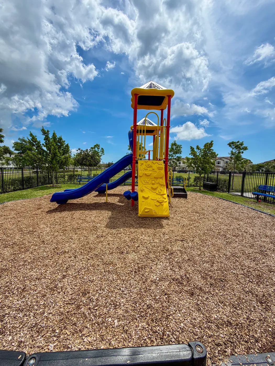 Play tower with peaked roof and blue slide at Siena Reserve
