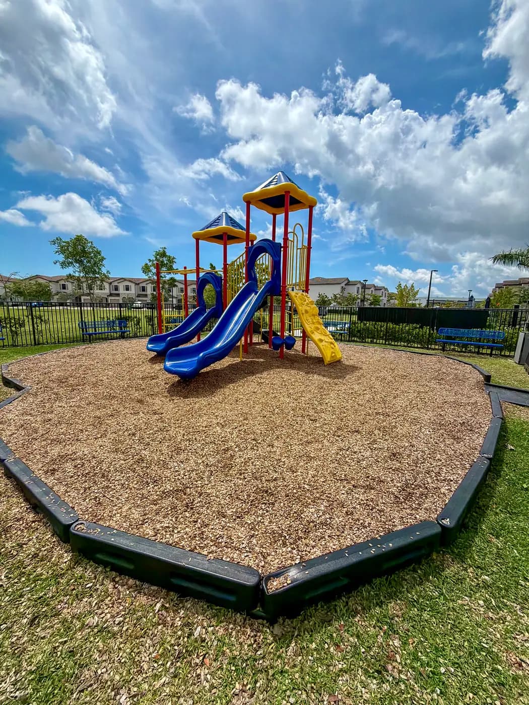 Two-tower play system with peaked roofs and twin blue slides