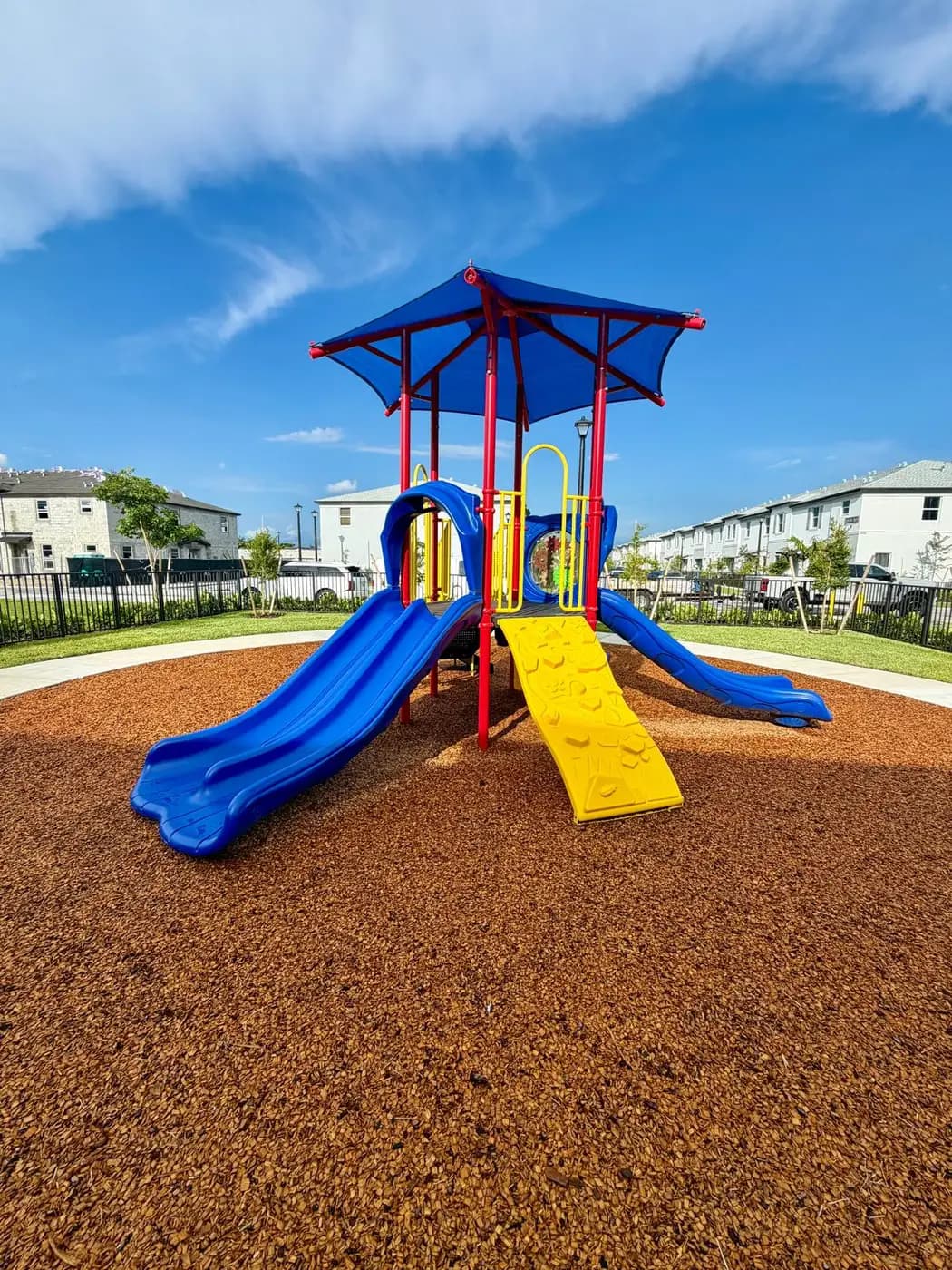 Solstice playground with townhomes behind