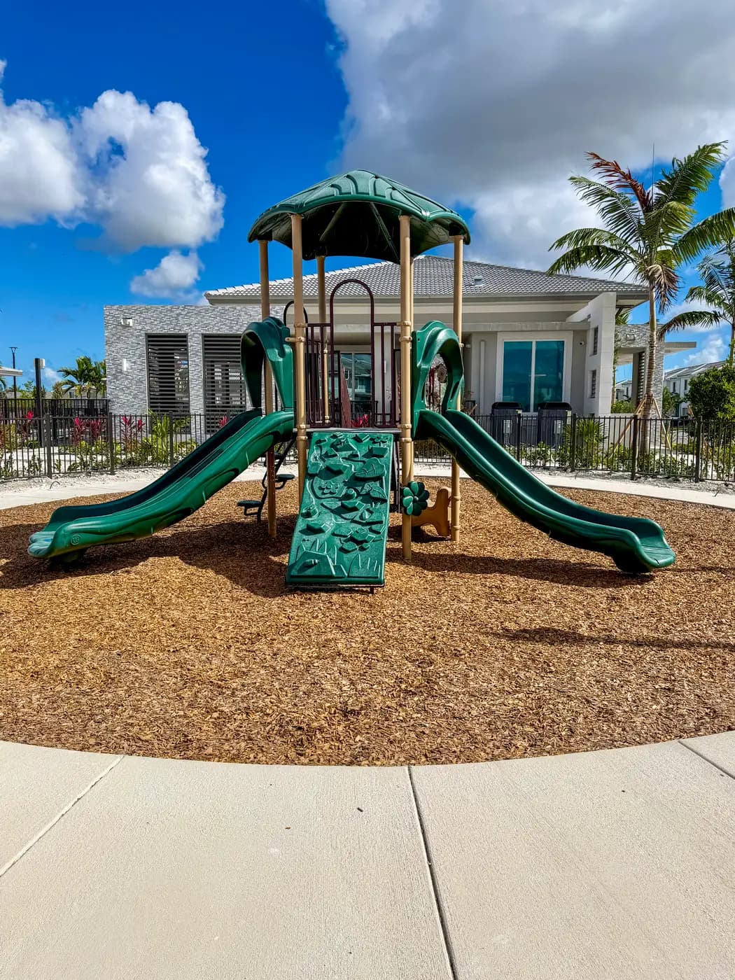 Green slides and climber on the Terra Sol playground