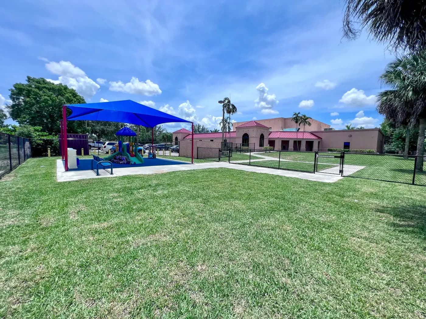 Blue hip shade over the play area beside the Universal Truth Center building