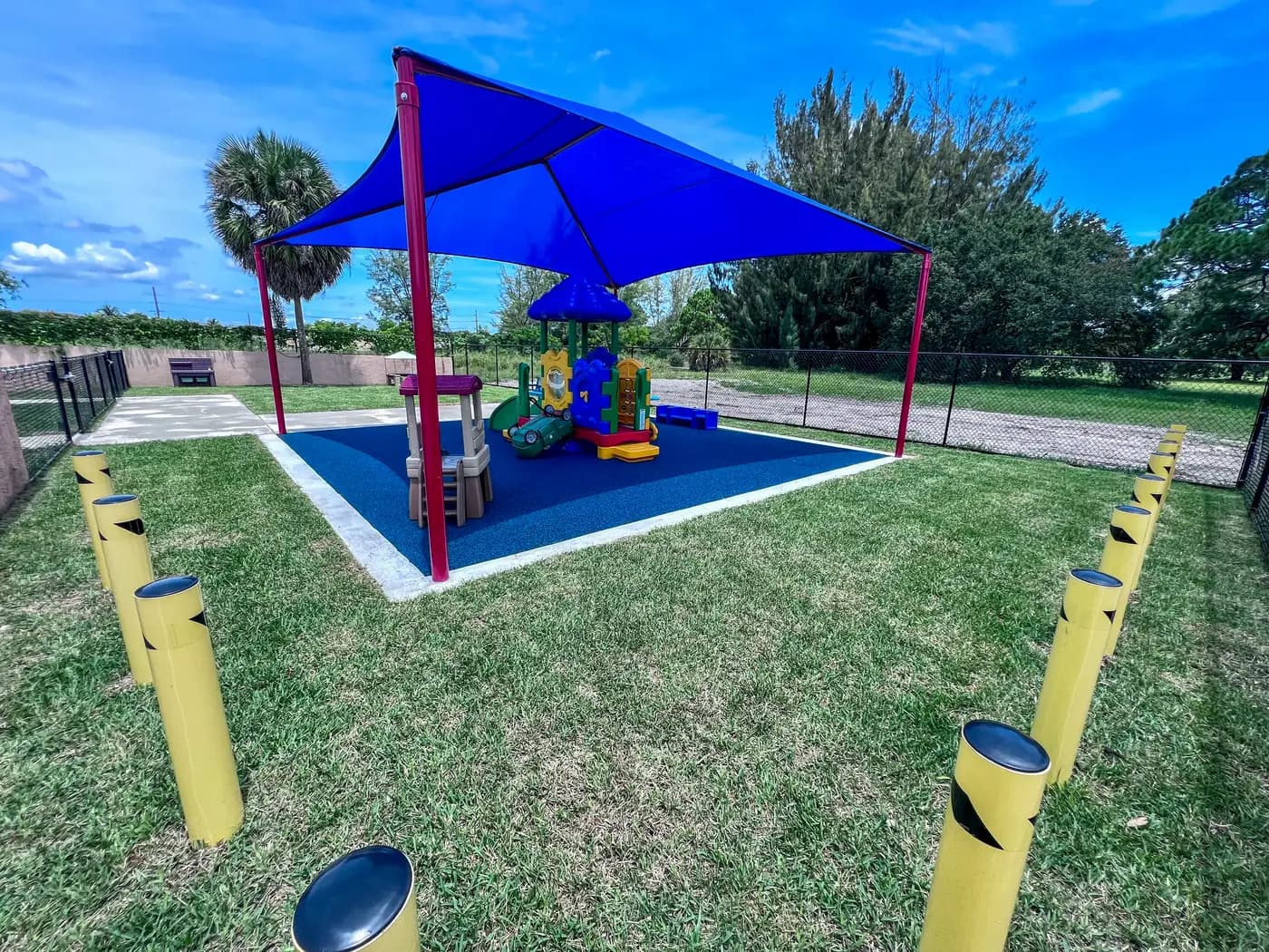 Blue shade structure over poured rubber at the Universal Truth Center