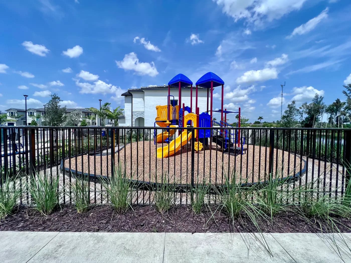 Viewpoint playground ringed by low black metal fencing