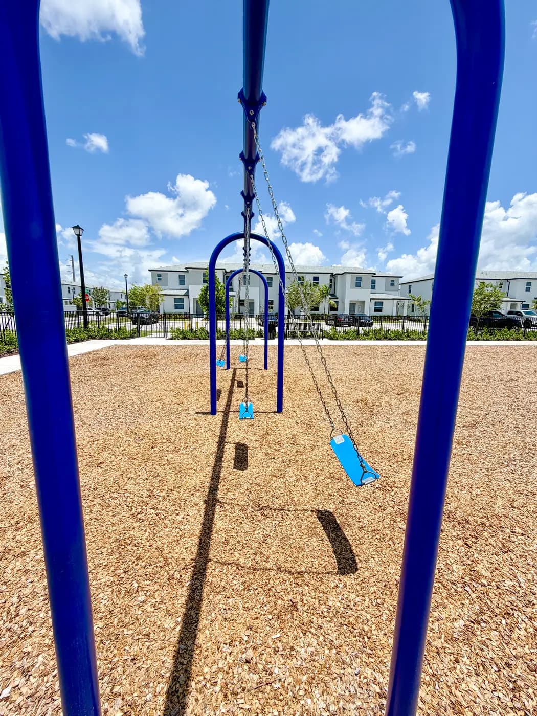 Arched blue swing frames with belt and toddler seats