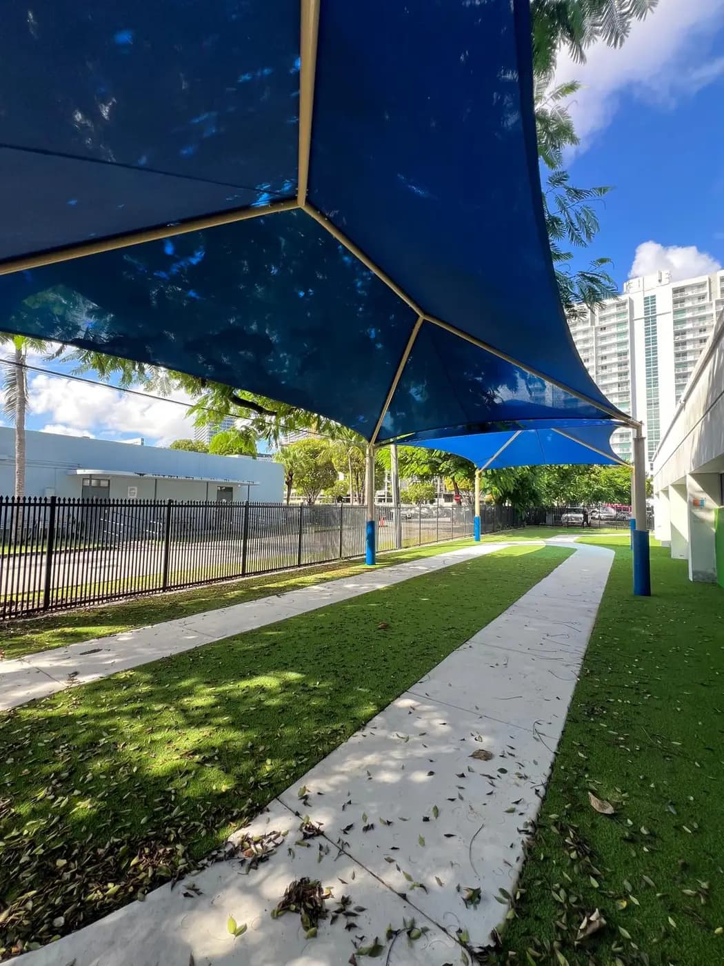 Underside of a double hip shade canopy shading an outdoor walkway