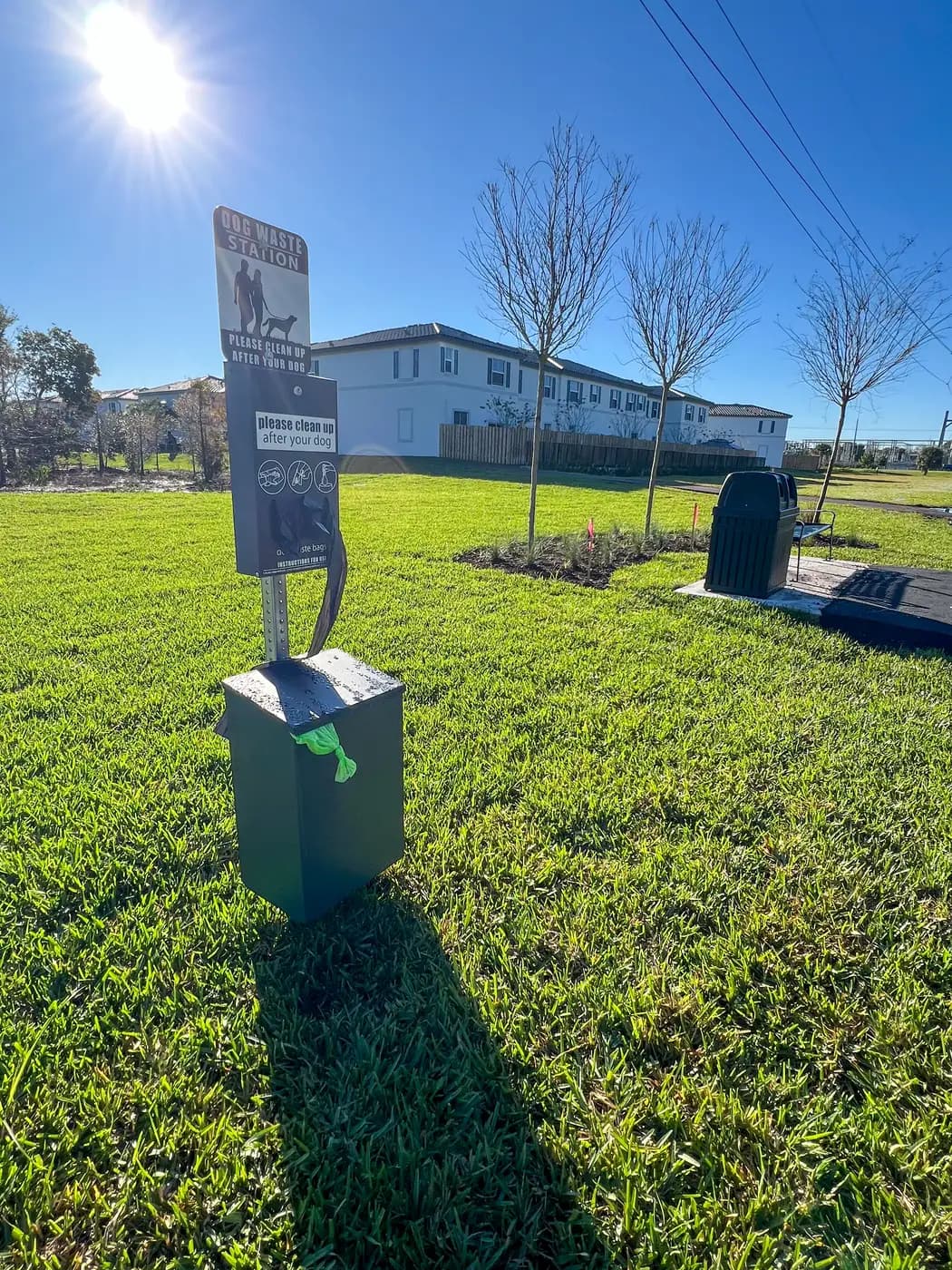 Dog waste station and bench along a community walking path