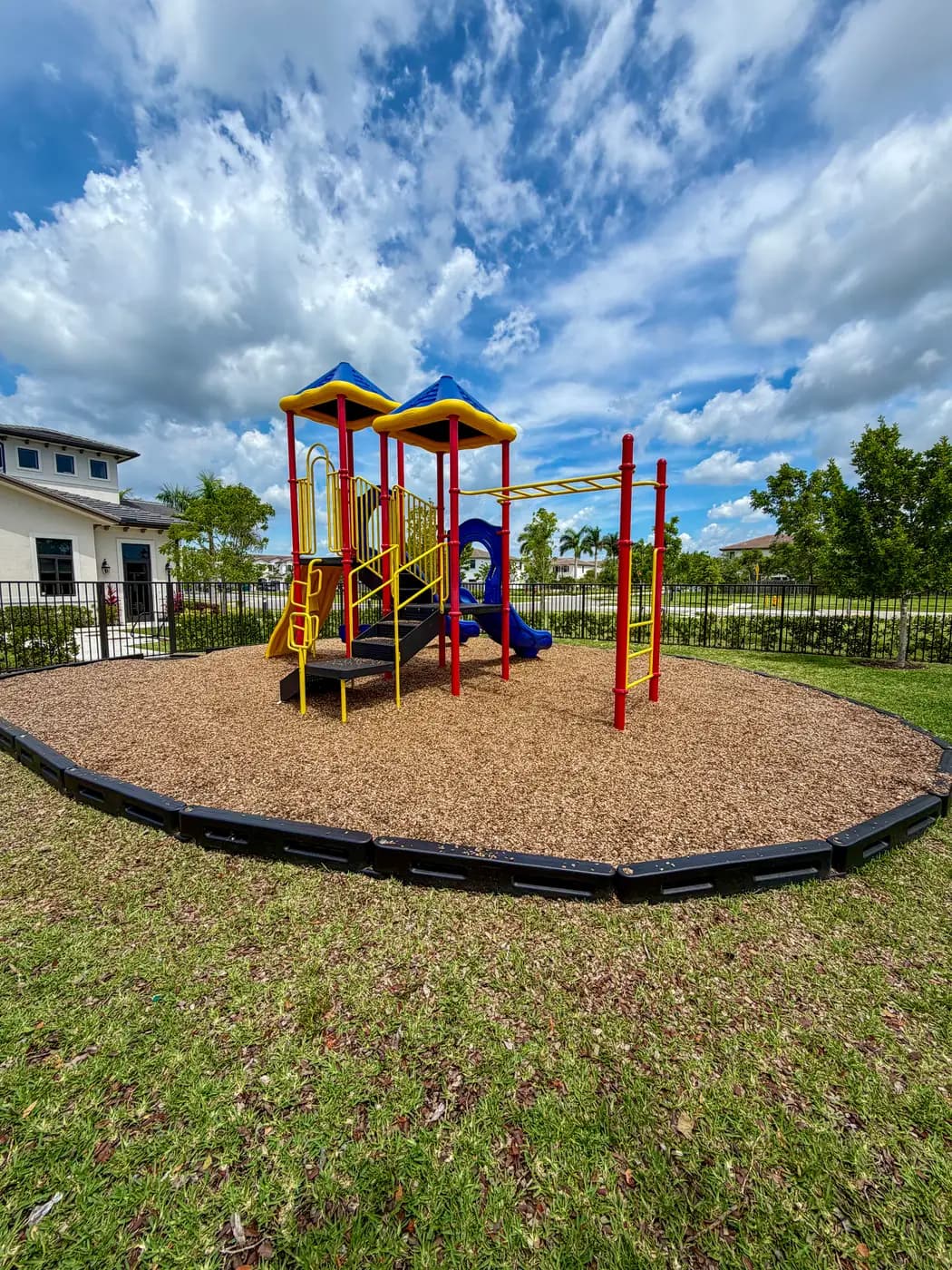 Siena Reserve playground among palms and landscaping