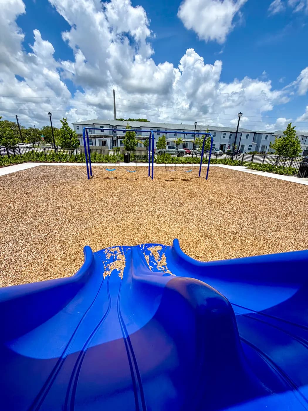 Swing frame and open play area at the Vivant Community park