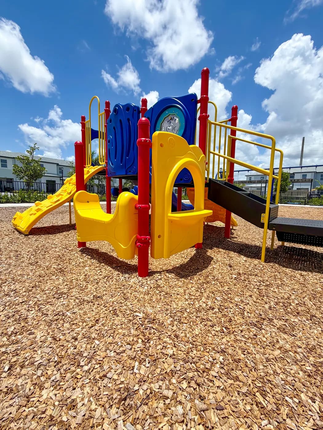 Play system with yellow slides and blue tower at Vivant