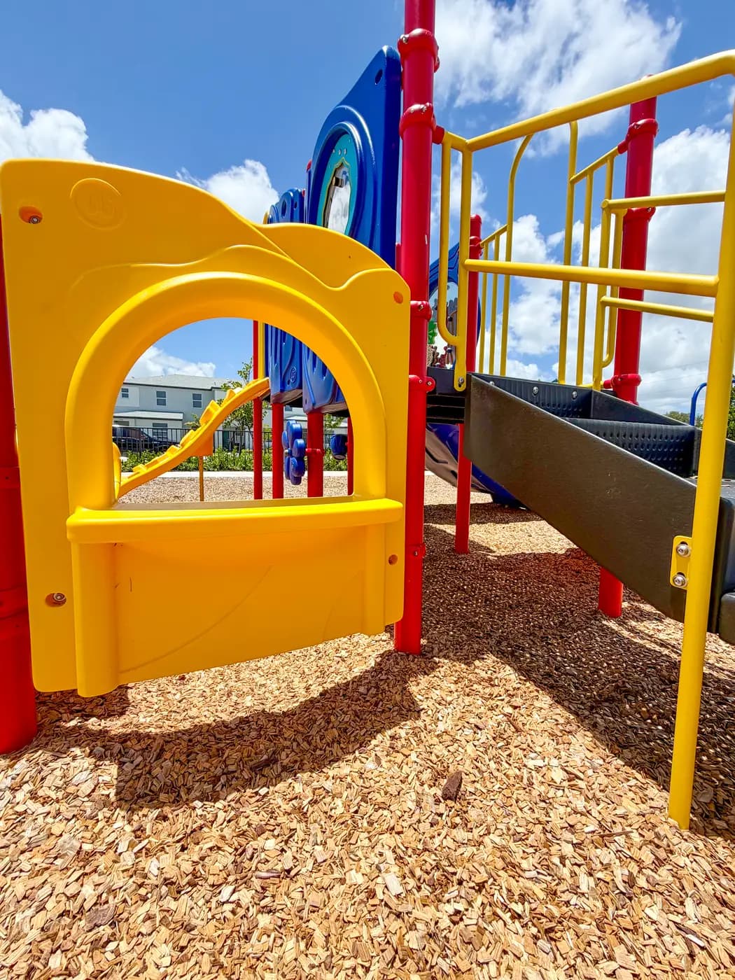 Yellow tube slide and climbing deck at Vivant