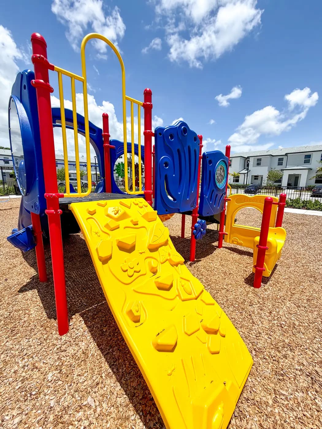 Yellow climber and red posts on the Vivant play structure